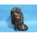 An antique oriental patinated bronze of Buddah, standing with right arm raised, 9½in (24cm) high.