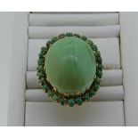 A large turquoise Dress Ring, the oval cabochon central stone, 24mm long, with a border of