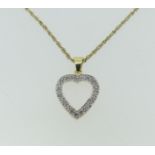 An 18ct yellow gold open heart shaped Pendant, set with diamond points, marked 750, 1.8g, on a 9ct
