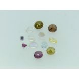 A collection of twelve loose semi-precious stones, including four moonstone, three testing as