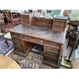 An Edwardian walnut twin Pedestal Desk, by Maple & Co. Ltd., with raised back and tooled leather