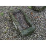 An antique granite rectangular Trough, 35in long x 16½in wide x 9in high (89cm x 42cm x 23cm). Note;