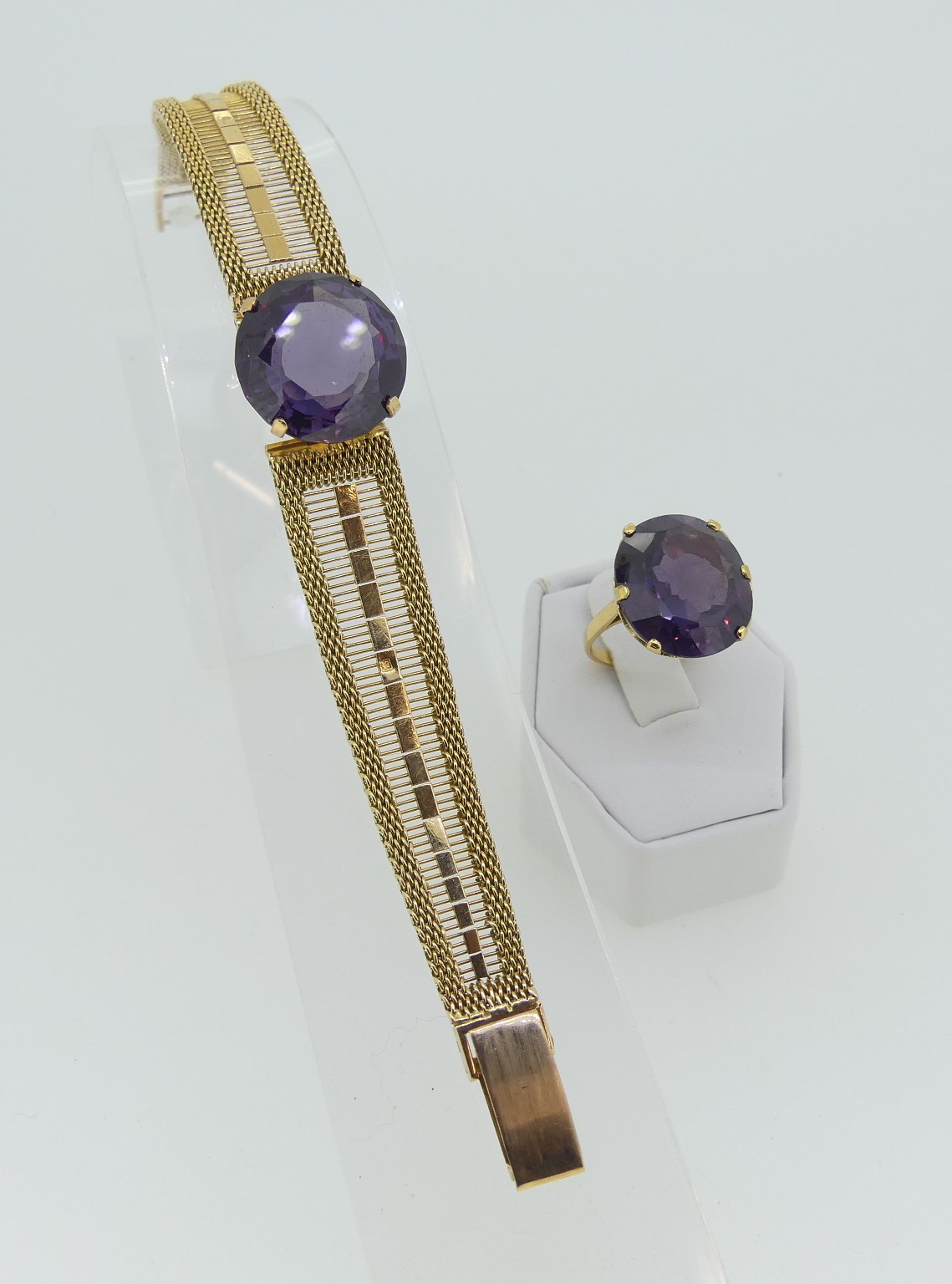 A yellow gold Bracelet, the front with a circular facetted colour change sapphire (resembling