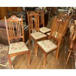 A set of five Arts and Crafts walnut Dining Chairs, each with central circular detailing to top