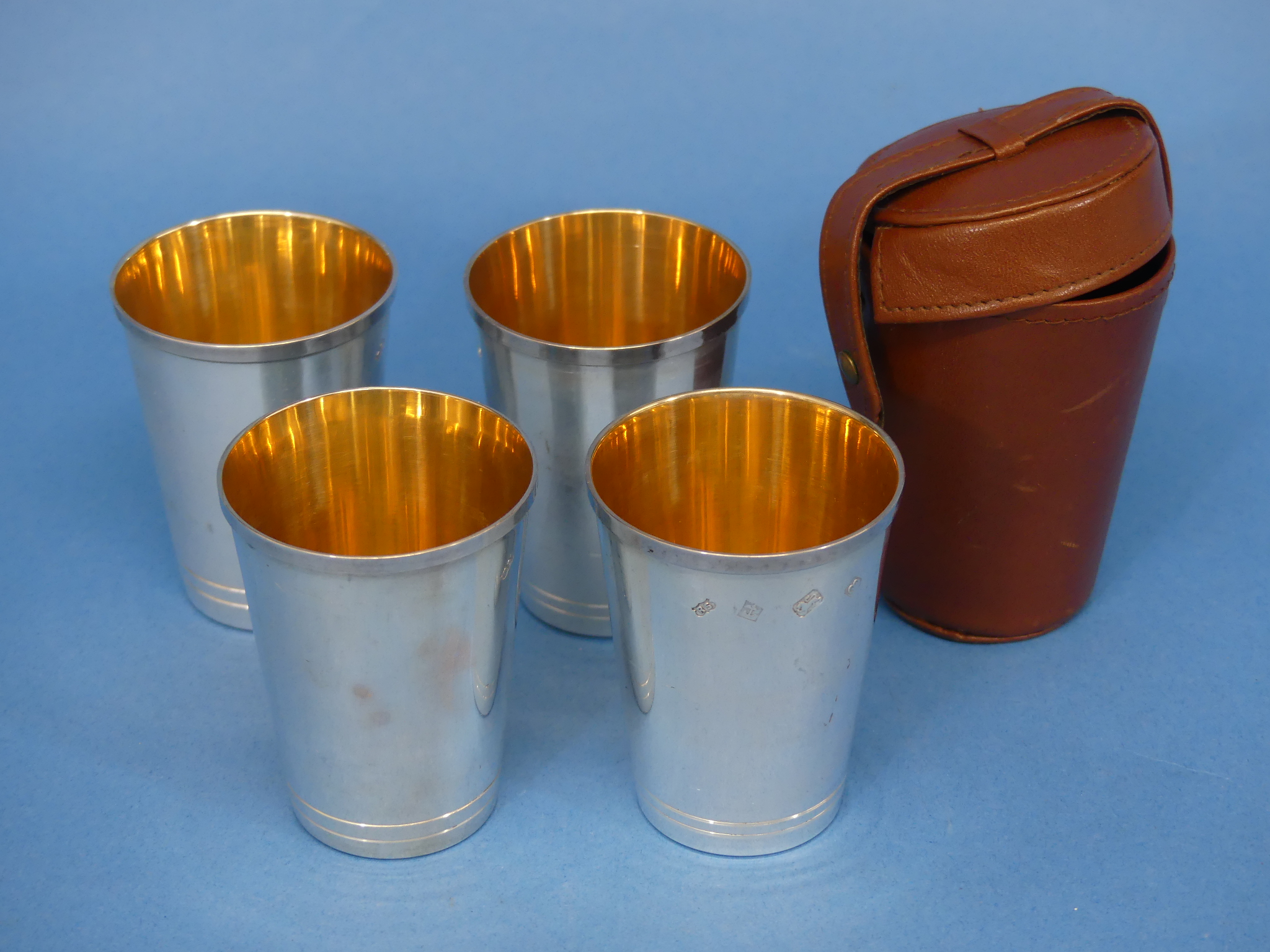 A cased set of four Elizabeth II silver Beakers, hallmarked Birmingham, 1979, plain with gilt