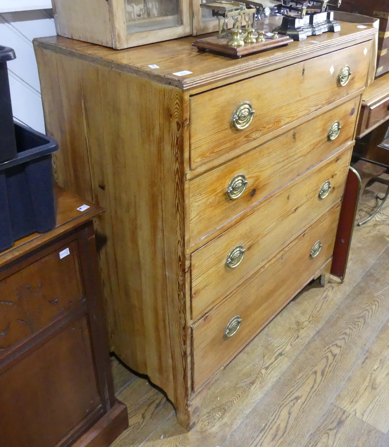 An antique pine Chest of Drawers, the four long drawers graduating in size raised on bracket feet,