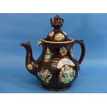 A Victorian Bargeware treacle glazed Teapot and cover, the body applied with relief moulded floral