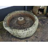 An antique granite circular Grinding Trough, 41in diameter x 14in high (104cm x 35.5cm). Note;