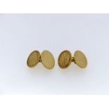 A pair of 9ct yellow gold oval Cufflinks, one side with engine turned decoration, the other plain,