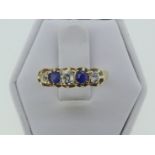 A small sapphire and diamond five stone Ring, with three circular cut diamonds with two sapphires