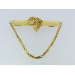 An 18ct yellow gold Tie Pin, formed of a wide gold bar with a central filigree map of Africa, with a