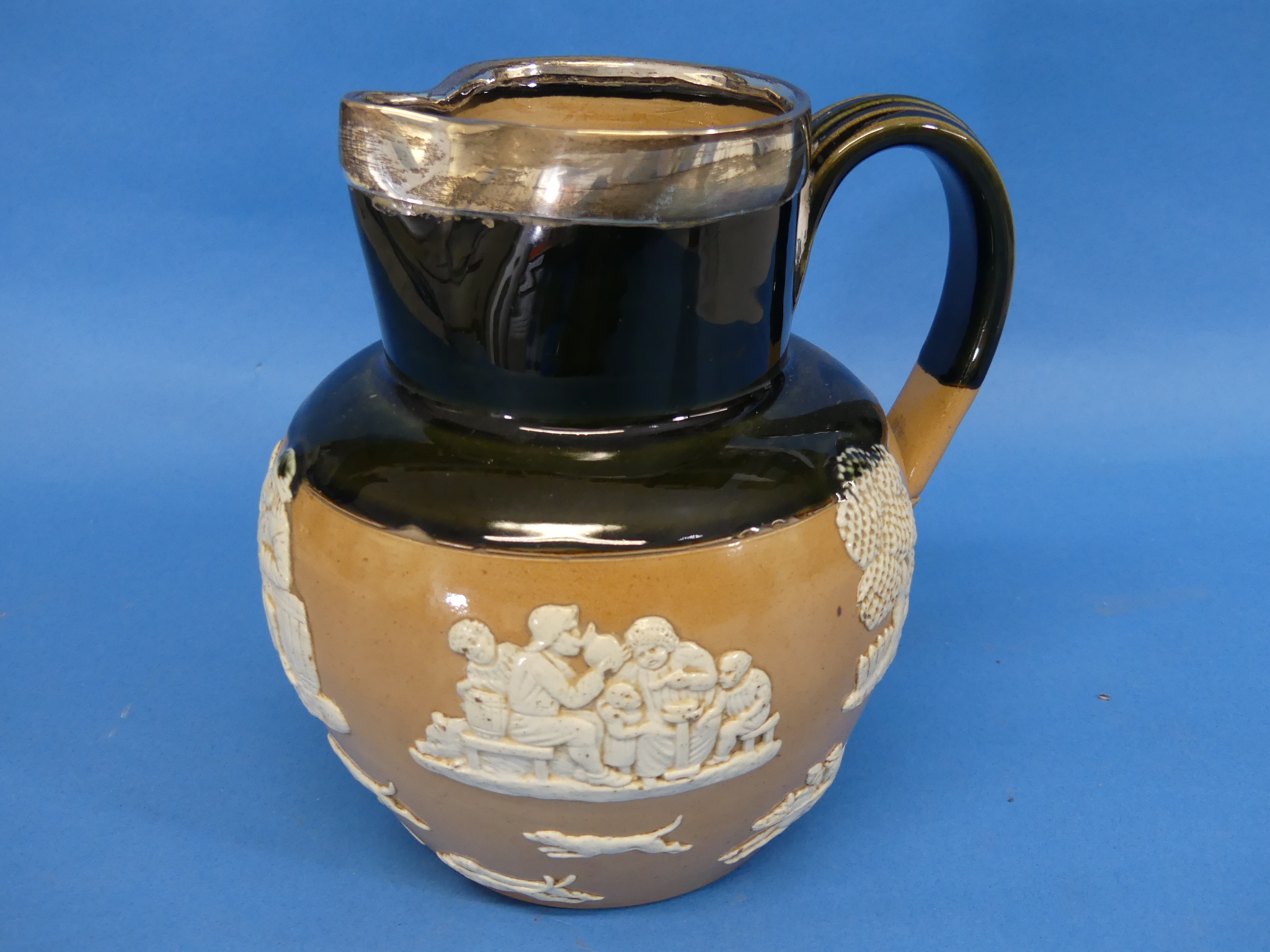 A Royal Doulton stoneware Harvest Jug, part green glazed with applied decoration and silver- - Image 6 of 8