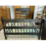 An early 20thC Indian rosewood Bedstead, the heavily carved foliate headboard interspersed with