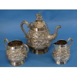 An Indian silver three piece Tea Set, of circular form with scroll handles, the teapot with finial