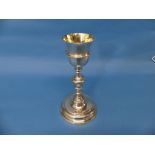 A 19thC German silver Goblet Chalice, with a stepped circular foot and long knopped stem, gilt