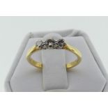 A small three stone diamond Ring, in an 18ct yellow gold shank, Size M½.