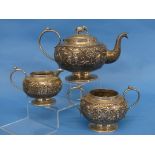 An Anglo-Indian silver three piece Tea Set, unmarked but tested, of circular form, the teapot with