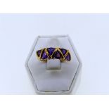 A six stone amethyst Ring, each triangular shaped stone with a gold spacer between, marked 375 on