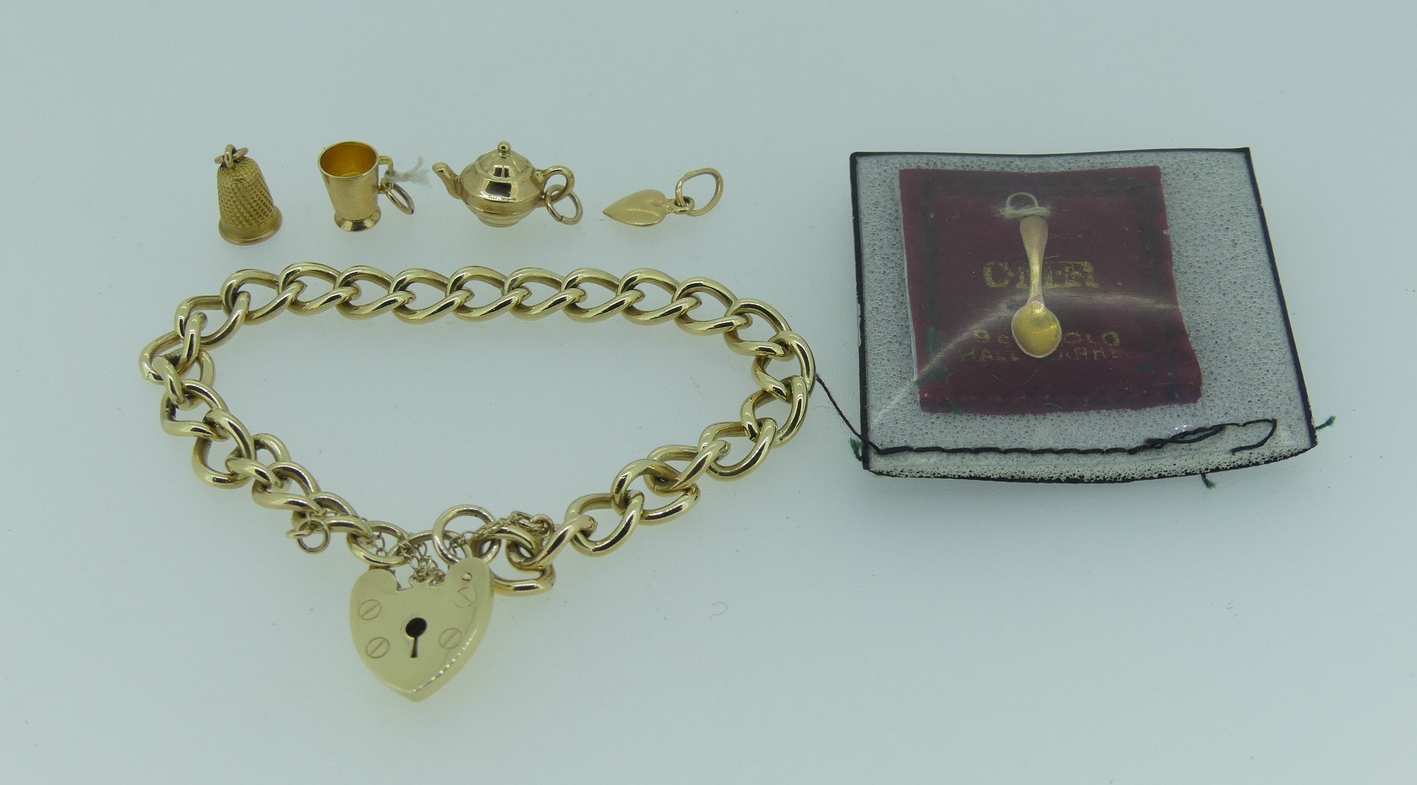 A 9ct yellow gold link Bracelet, with 9ct yellow gold padlock clasp and safety chain, together