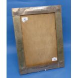 An Arts & Crafts silver-plated rectangular photo / picture frame, with hammered decoration, formerly