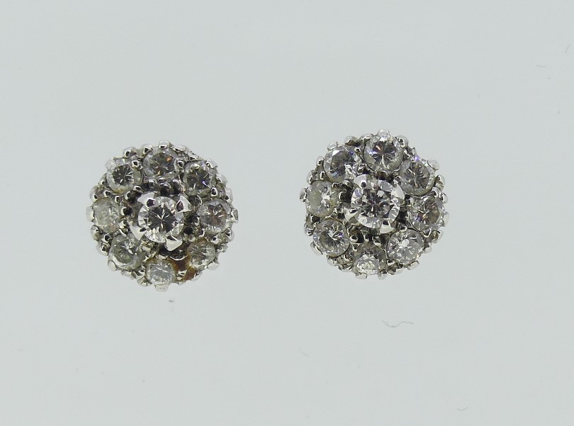 A pair of small diamond cluster Ear Studs, the central stone with eight diamonds around, all mounted