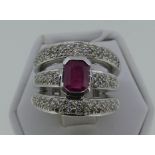 A ruby and diamond Dress Ring, the flared front formed of three bands, all with pave-set diamonds,