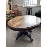 A Victorian oak Breakfast Table, the oval top with incised decoration to the edge, raised on bulbous