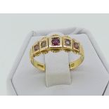 A Victorian 15ct gold Ring, set three garnets and two seed pearls, Size P