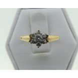 A diamond set flowerhead cluster Ring, the central stone surrounded by six smaller, approx total