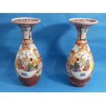 A pair of Japanese imari Vases, of ovoid form with flared necks, decorated with figures and