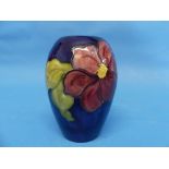 A Moorcroft 'Clematis' pattern Ovoid Vase, the tube-line design with impressed marks to the base,