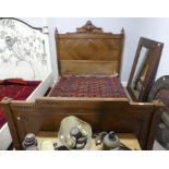 An antique French carved walnut double Bedstead, the head and base boards with quarter-veneer