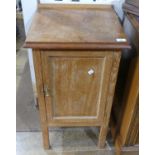 An early 20thC oak Pot Cupboard, of square form with single panelled door, 17in (43cm) wide, 31in (