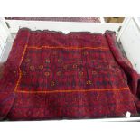 Tribal rugs; an old Turkmen Kurdish red ground rug, coarsely woven and hand-knotted with four