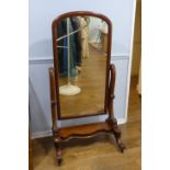 A Victorian mahogany Cheval Mirror, the arched-top rectangular plate within a pivoting frame with