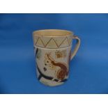 A large Brannam Pottery Mug, naively adorned in sgrafitto decoration each side with red squirrels on