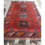 Tribal rugs; an old Caucasian Kazak red ground rug, coarsely woven and hand knotted with four