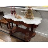 A late Victorian mahogany marble-topped Washstand, of serpentine form with raised back above a