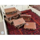 Six various vintage brown leather / leather style Suit Cases, smallest 14in (35.5cm) wide, largest
