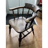 An early 20thC smokers bow Armchair, 24in (61cm) wide, 30½in (77.5cm) high.