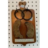 East Devon interest: two parts of a broken horseshoe, in very rusty condition, mounted on a wooden