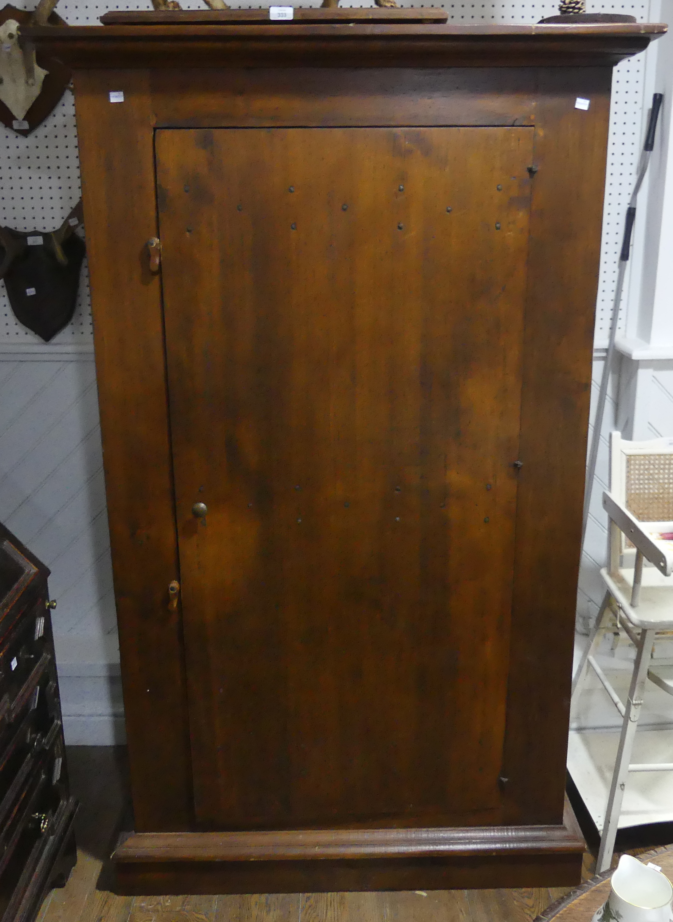 An antique-style Cupboard, made of stained reclaimed timber, the door with metal studwork