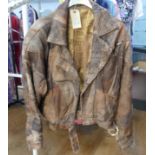 Vintage Fashion, circa late 1980s: a ladies distressed patchwork brown leather bomber jacket, with