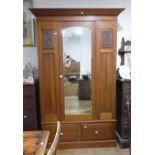 An Edwardian mahogany Wardrobe, with single mirrored door and a drawer below, 54in (137cm) wide x