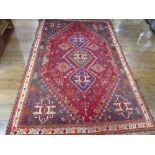 Tribal rugs; a Persian Qashqai red and blue ground rug, the whole woven with stylised tree of life