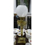An Edwardian brass Oil Lamp, of classical column form on stepped square base, with white glass shade