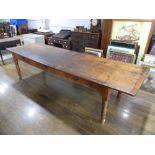 A large early 20thC pine plank top Kitchen Table, with three frieze drawers, 124½in (316cm) long,