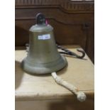 A vintage brass Ships Bell, with associated iron bracket, bell: 11in (28cm) high x 10in (25.5cm)