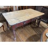 A vintage pine Kitchen Table, with two frieze drawers on one long edge, some damage to bottom of