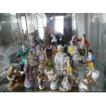 A quantity of Figurines, mostly continental porcelain figural groups, but also including Hummel,